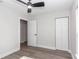 Bedroom featuring an open door, closet, ceiling fan, and laminate flooring at 11415 Nw 15Th St, Ocala, FL 34482
