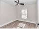Bright bedroom with ceiling fan, window, and laminate flooring at 11415 Nw 15Th St, Ocala, FL 34482