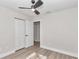 Bedroom featuring closet, ceiling fan, base molding, and laminate flooring at 11415 Nw 15Th St, Ocala, FL 34482