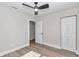 Bedroom featuring an open door, closet, ceiling fan, and laminate flooring at 11415 Nw 15Th St, Ocala, FL 34482