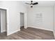 This bedroom has light gray paint, wood-look flooring, a ceiling fan, and a window at 11415 Nw 15Th St, Ocala, FL 34482