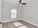 Bright bedroom with ceiling fan, window, and laminate flooring at 11415 Nw 15Th St, Ocala, FL 34482