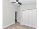 Bedroom featuring an open door, closet, ceiling fan, and laminate flooring at 11415 Nw 15Th St, Ocala, FL 34482