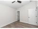 Bedroom featuring an open door, closet, ceiling fan, and laminate flooring at 11415 Nw 15Th St, Ocala, FL 34482