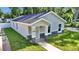 Charming single-story home with a covered entry, featuring stone accents and fresh landscaping at 11415 Nw 15Th St, Ocala, FL 34482