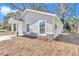 This home has a well-maintained exterior with stone accents and manicured landscaping at 11415 Nw 15Th St, Ocala, FL 34482