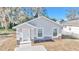 Charming single-story home with a bright, white exterior and lovely stone accents at 11415 Nw 15Th St, Ocala, FL 34482