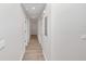Hallway with neutral walls and wood-look flooring at 11415 Nw 15Th St, Ocala, FL 34482
