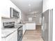 Modern kitchen features stainless appliances, eat in counter, stone countertops, and ample lighting at 11415 Nw 15Th St, Ocala, FL 34482