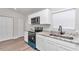 Well-lit kitchen showcasing stainless appliances, stone countertops, and white cabinets at 11415 Nw 15Th St, Ocala, FL 34482