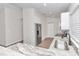 Bright kitchen features stainless steel refrigerator, white cabinets, and stone countertops at 11415 Nw 15Th St, Ocala, FL 34482