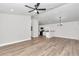 Spacious living room with an open floor plan, ceiling fan, and sleek, modern finishes at 11415 Nw 15Th St, Ocala, FL 34482