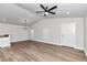 Well-lit living room featuring an open layout, hardwood floors, and modern ceiling fan at 11415 Nw 15Th St, Ocala, FL 34482