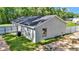 An exterior of the back of the house featuring a metal fence and grass at 11415 Nw 15Th St, Ocala, FL 34482