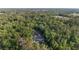 Expansive estate nestled within lush trees boasts a private pool, long driveway, and inviting facade at 1251 Sw 43Rd Pl, Ocala, FL 34471