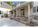 Exterior view of the home featuring a stone patio and luscious backyard at 1251 Sw 43Rd Pl, Ocala, FL 34471