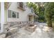 Exterior view of the home featuring a stone patio with a built-in fire pit and backyard at 1251 Sw 43Rd Pl, Ocala, FL 34471
