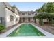 Large backyard with a sparkling pool, lush landscaping, and a vine-covered pergola creating a serene oasis at 1251 Sw 43Rd Pl, Ocala, FL 34471