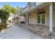 Exterior view of the home featuring a stone patio, porch, and luscious backyard at 1251 Sw 43Rd Pl, Ocala, FL 34471