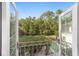 Balcony with a view of lush greenery, pool, and manicured grounds at 1251 Sw 43Rd Pl, Ocala, FL 34471