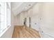 Bonus room featuring wood floors, a large window, and multiple doors at 1251 Sw 43Rd Pl, Ocala, FL 34471