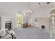 Bonus room with fireplace, chandelier, french doors to the exterior, and gray carpeting at 1251 Sw 43Rd Pl, Ocala, FL 34471