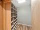 Walk-in closet with wood shelving and laminate flooring, great for organizing clothing and accessories at 1251 Sw 43Rd Pl, Ocala, FL 34471