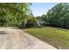 View of house showcasing manicured lawn, a vine covered pergola, and tranquil surroundings at 1251 Sw 43Rd Pl, Ocala, FL 34471