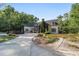 Sprawling home featuring elegant architecture, a long drive, and well-manicured landscaping at 1251 Sw 43Rd Pl, Ocala, FL 34471