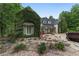 Charming home covered in greenery, featuring unique architectural details and a well-manicured landscape at 1251 Sw 43Rd Pl, Ocala, FL 34471