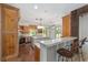 Gourmet kitchen featuring stainless steel appliances, custom cabinetry, an island, and a breakfast bar at 1251 Sw 43Rd Pl, Ocala, FL 34471