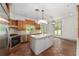Bright kitchen with terra cotta floors, white island, and stainless steel appliances at 1251 Sw 43Rd Pl, Ocala, FL 34471