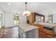 Bright kitchen featuring a marble-topped island, stainless appliances, and white walls at 1251 Sw 43Rd Pl, Ocala, FL 34471
