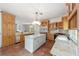 Kitchen features include a central island, stainless fridge, and wood cabinetry at 1251 Sw 43Rd Pl, Ocala, FL 34471