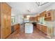 Spacious kitchen with wood cabinets, terra cotta floors, and central island at 1251 Sw 43Rd Pl, Ocala, FL 34471