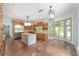 Open kitchen area with terra cotta floors, stainless fridge, and natural light at 1251 Sw 43Rd Pl, Ocala, FL 34471