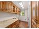 Laundry room with wooden cabinetry, sink, and terra cotta tile floors at 1251 Sw 43Rd Pl, Ocala, FL 34471