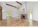 Inviting living room featuring hardwood floors, a brick fireplace, and ample natural light at 1251 Sw 43Rd Pl, Ocala, FL 34471