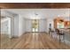 Open living space with hardwood floors, exposed beam, transitional breakfast bar, and access to other rooms at 1251 Sw 43Rd Pl, Ocala, FL 34471
