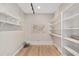 Bright office space with built-in bookshelves, floating shelves, and light wood floors at 1251 Sw 43Rd Pl, Ocala, FL 34471