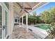 Covered patio with stone flooring, a built-in grill, and overlooking a swimming pool and lush landscaping at 1251 Sw 43Rd Pl, Ocala, FL 34471