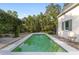 Backyard featuring a swimming pool surrounded by a patio and lush greenery at 1251 Sw 43Rd Pl, Ocala, FL 34471