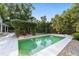 A serene pool offers a refreshing retreat, surrounded by landscaped grounds and lush greenery at 1251 Sw 43Rd Pl, Ocala, FL 34471