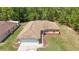Aerial shot of a single-story home featuring a spacious yard, garage, and a well-kept roof at 13173 Sw 65Th Cir, Ocala, FL 34473