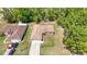 Aerial view of a well-maintained home with a large yard, driveway, and mature trees at 13173 Sw 65Th Cir, Ocala, FL 34473