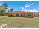 The back of the single story home with sliding glass door and large back yard at 13173 Sw 65Th Cir, Ocala, FL 34473