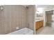 Bathroom with tiled shower over tub and wooden vanity at 13173 Sw 65Th Cir, Ocala, FL 34473