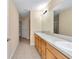 Bathroom featuring double sinks, vanity with cabinets, and tile flooring at 13173 Sw 65Th Cir, Ocala, FL 34473