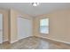 This bedroom offers tile flooring, natural light from a window, and closet at 13173 Sw 65Th Cir, Ocala, FL 34473