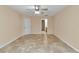 Spacious bedroom features tile flooring and bright lighting at 13173 Sw 65Th Cir, Ocala, FL 34473